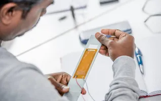Man looking at composite structures in his hands
