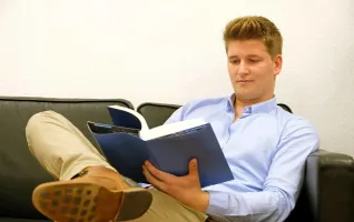 Student reading in a book about reasons to get an MBA degree