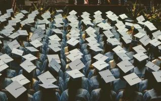 Master's degree graduates wear graduation gowns and caps during ceremony