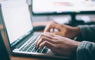 Person using digital technology macbook pro