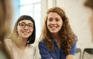 Two girl students socialising at university