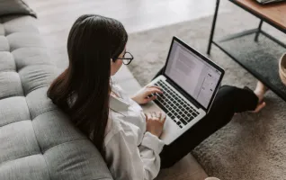 Woman pursuing MBA writing on her laptop