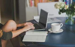 Student typing a pre-semester checklist on laptop