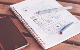 notebook with ux design wireframes