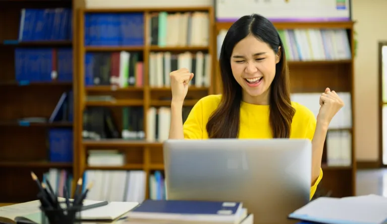 Studentin freut sich über Zulassung nach erfüllten Fernstudium-Zugangsvoraussetzungen