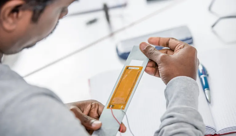 Man looking at composite structures in his hands