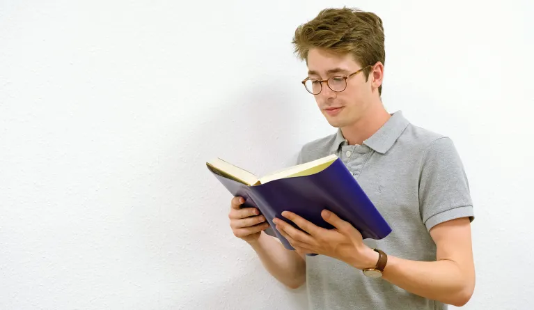 Student reading a book about sales psychology