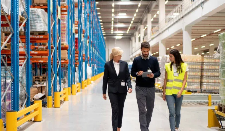 Studentin läuft durch das Lager nach BWL Abschluss mit Schwerpunkt Logistikmanagement 