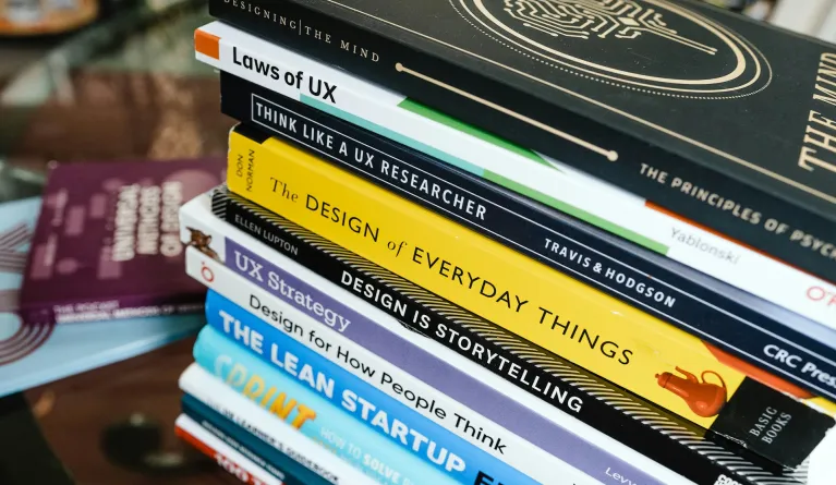 Stack of books about UX design
