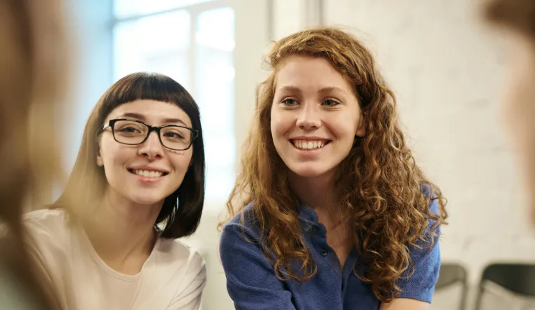 Two girl students socialising at university