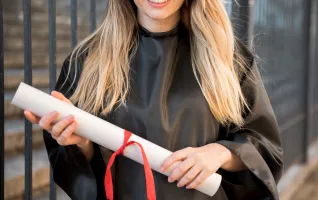 Front view girl smiling holding her master's degree diploma